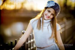 Young girl leaning on a railing outdoors