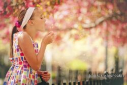 Young girl outdoors with colorful flowers in the background