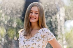 Smiling teenage girl in a floral top outdoors