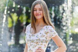 Teenage girl posing outdoors in soft light