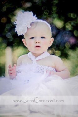 Baby in a white dress outdoors