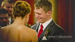 Groom smiling in a natural light portrait.