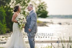 Bride and groom embracing outdoors near the venue.