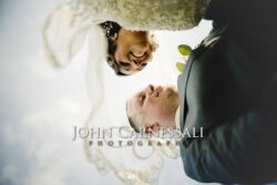 Low-angle portrait of smiling bride and groom