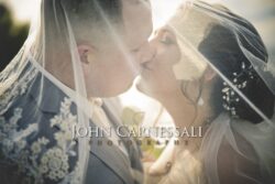 Close-up of couple kissing under veil