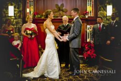 Bride and groom standing together during their wedding ceremony indoors