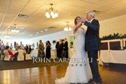 Bride and groom slow dancing in the reception ballroom.