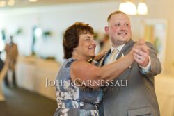 Two wedding guests dancing together at the reception.