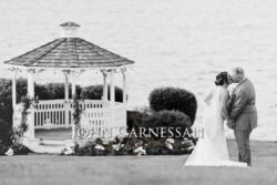 Black-and-white image of a waterfront gazebo at the wedding venue.