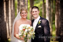 Bride and groom smiling together with bouquet