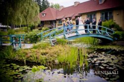 Inn exterior with pond and blue bridge