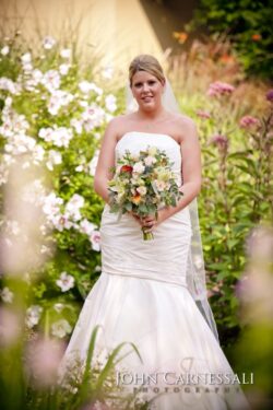 Bride standing outdoors with her bouquet