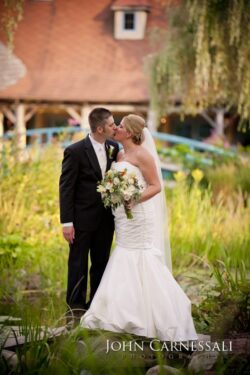 Bride and groom standing together outdoors