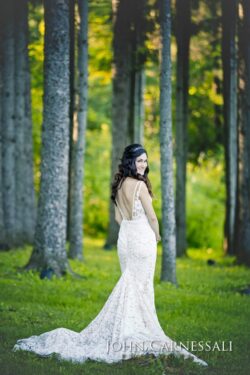 Bride standing in a wooded outdoor setting
