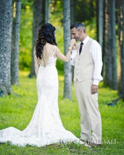 Bride and groom standing together among trees