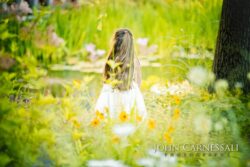 Bride standing in a field of flowers