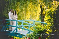 Bride and groom standing together on the garden bridge