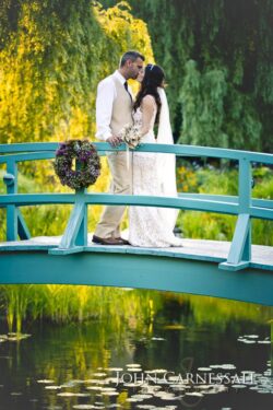 Bride and groom posing together on the blue garden bridge