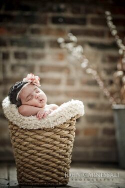Sleeping newborn in a woven basket