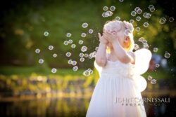 Little girl playing with bubbles outdoors
