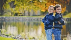 Young boy standing near the water outdoors