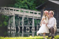 Little girl standing near a wooden bridge outdoors