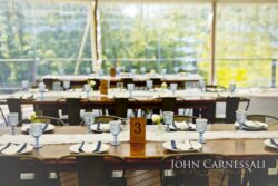 Reception table with candles, glassware, and a table number