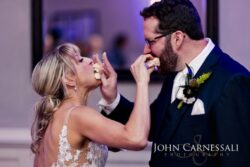 Bride and Groom feeding each other cake at their wedding recepiton