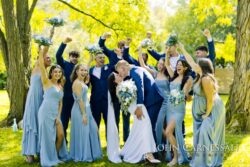 Wedding party cheering together outdoors