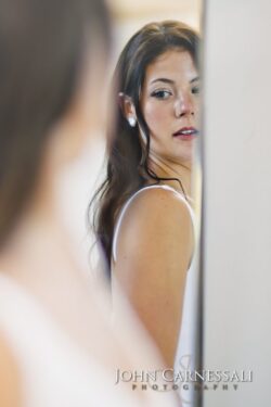 Bride glancing back in a mirror portrait