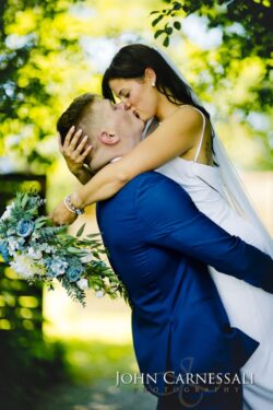 Bride and groom hugging outdoors
