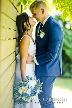 Bride and groom standing together in warm sunlight