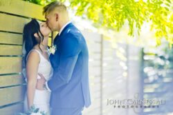 Bride and groom standing close together outside