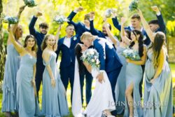 Wedding party celebrating around the bride and groom