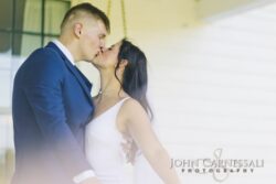Bride and groom kissing outdoors
