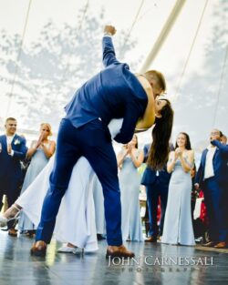Groom dipping the bride for a kiss outdoors