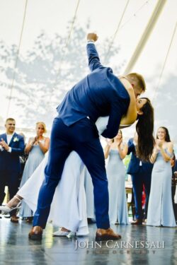 Bride and groom sharing a dip kiss outside